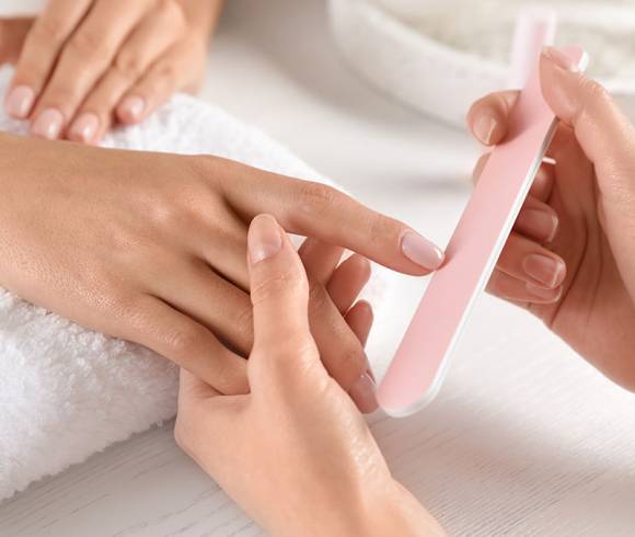 Classic manicure with filing, cuticle care and shaping for a neat and polished appearance.