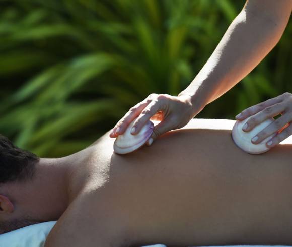 Full-body massage with warm shells and flowing strokes to relieve tension and enhance relaxation.