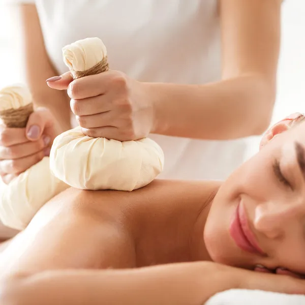 Eine Frau entspannt bei einer ayurvedischen Massage im Wellnessbereich des Grand Hotel Binz mit vielen Ayurveda-Angeboten.