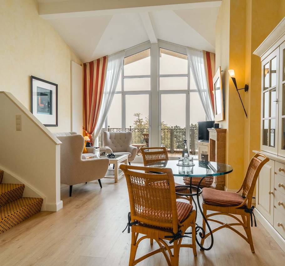 Luxurious penthouse at the Grand Hotel Binz with open-plan living area, large windows, and views of the Baltic Sea.
