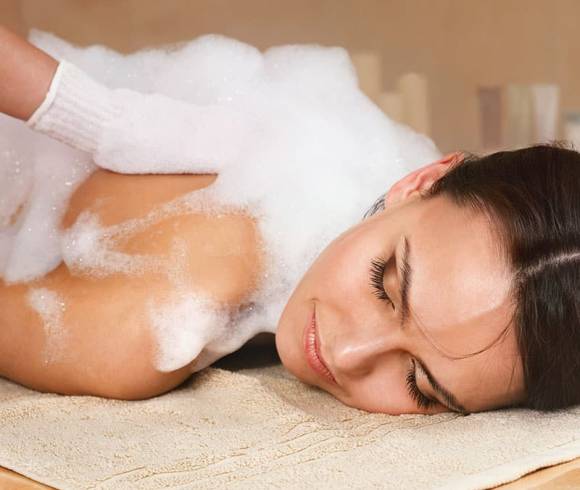 Oriental body cleansing with foam, special glove and peeling on the warm stone bench in the hammam.