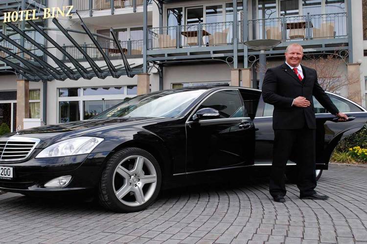 Elegant limousine in front of the Grand Hotel Binz, the driver opens the door for the next vacation.