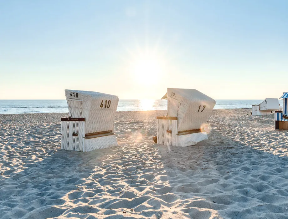 Summer beach chairs on the sandy beach in front of Grand Hotel Binz with sea view