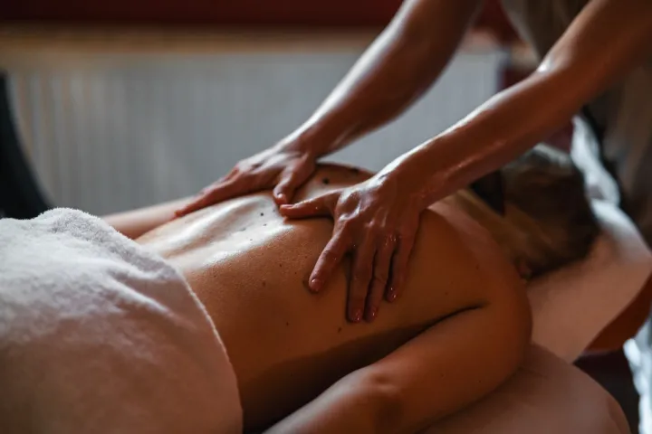 Gast genießt eine entspannende Rückenmassage im Wellnessbereich des Grand Hotel Binz.