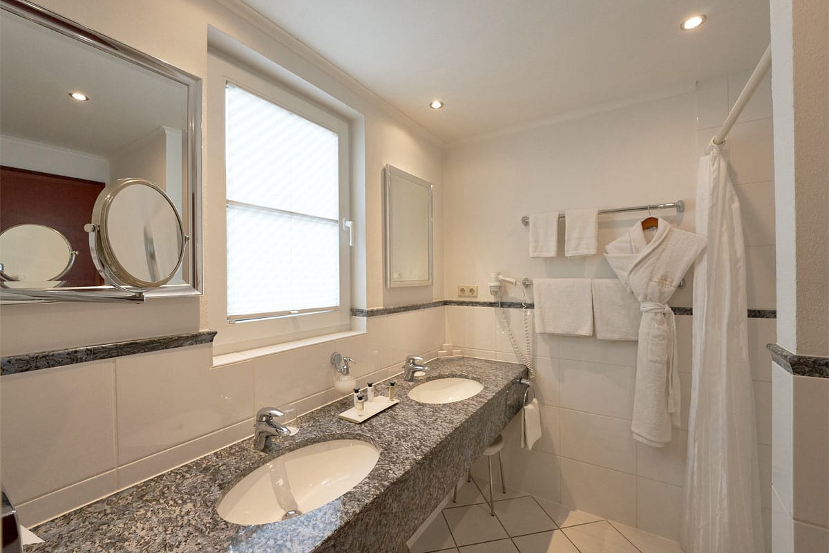 Modern bathroom at Grand Hotel Binz with two sinks and elegant details.